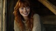 © Tatyana - Joyful woman with red hair smiling happily, wearing a cozy sweater, enjoying life in a rustic setting. Natural beauty shines through.