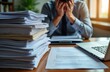© Pete - Stressed businessman faces paperwork overload in office. Man buried in documents. Looks exhausted, overwhelmed by paperwork. Desk full of papers. Work environment stressful. Deadline approaching.