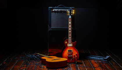 music show background with electric guitar and acoustic guitar and amplifier on dark background with free space for text