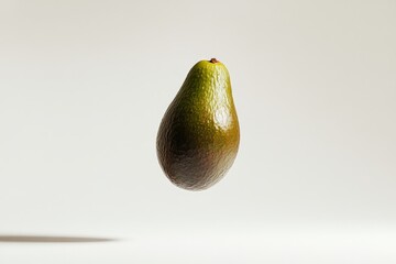 Aufkleber - A fresh green avocado elegantly floats in the air on a neutral backdrop, highlighting its smooth skin and plump shape, embodying health and simplicity.