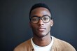 © ChaoticMind - A modern portrait of a confident man, wearing stylish glasses and a brown cardigan, gazing intently at the camera with an expression of poise and thoughtfulness.