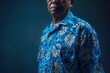 © Isuru - Man in blue batik government service attire for formal events.