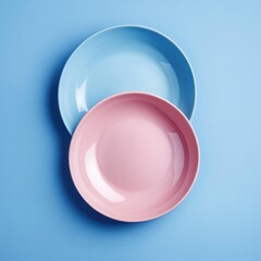 Poster - Pink and blue plates on blue background.