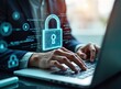 © miss irine - Business person works on laptop. Hands type on keyboard. Cyber security tech concept shown on screen. Lock, code graphic shows protection. Person manages secure system. Modern digital workspace.