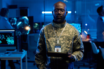Aufkleber - Young serious African American man in camouflage uniform looking at tablet screen while working in military command center