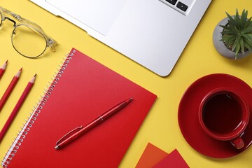 Poster - Designer's workplace. Flat lay composition with stationery, laptop and cup of coffee on yellow background