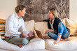 © ADDICTIVE STOCK - Couple Collaborating on a Home Project in Cozy Living Room