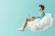 © Belvedere studio - Young man sitting on a cloud while working on a laptop in a bright and serene environment