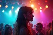 © Viktor - Young woman stands in crowded nightclub at night. Neon lights create vibrant colors. People enjoying party. Woman stylish make-up, long wavy hair. Dressed in casual trendy clothes. Nightlife scene