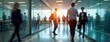 © Viktor - Busy business people walk in office corridor. Fast moving people in modern business center. Indoor shot of business professionals. Lots of people move quickly in office. Blurred motion creates sense