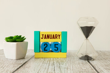 25 January calendar table with blurred nature background.