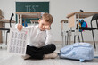 © Pixel-Shot - Upset schoolboy with results of test crying on floor in classroom