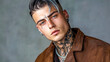 © edojob - Young influencer posing with tattoos and piercings, wearing brown jacket and silver chain