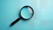 © Viktor - Black magnifying glass on light blue background. Top view. Business concept. Simple and clean design for website or app. Use for search concept. Great image to illustrate research or investigation