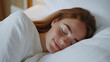 © Aris - Germany woman sleeping comfortably on white bed in luxury hotel