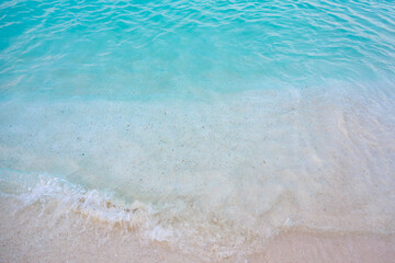 Wall Mural - A beautiful blue ocean with a sandy beach