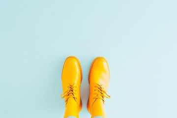 Aufkleber - Bright Yellow Boots on Minimalistic Light Blue Background in Top-Down View