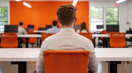Poster - Office worker sitting in orange chair in busy office