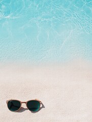 Poster - Sunglasses resting on sandy beach with clear turquoise water in background. Generative AI