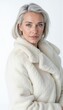 © InspirationDesign - Mature woman in white fur coat on light background. For luxury fashion and sophisticated lifestyle advertising.