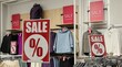 © roza27 - Sale in a clothing store, clothes hanging on hangers, signs indicating discounts
