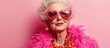 © The 2R Artificiality - Elderly woman in vibrant feather boa and heart-shaped sunglasses exuding joy and seasonal celebration against a pink backdrop with space for text