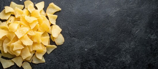 Poster - peeled and chopped potatoes arranged on a dark surface with empty space for text ideal for menu or r
