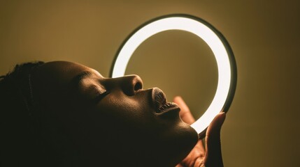 Canvas Print - Close-up of a woman's face illuminated by a circular light.