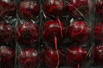 Wall Mural - Close-up view of fresh red beets in plastic packaging.