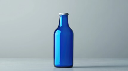 Poster - A glossy blue beer bottle featuring a blank label, isolated on a neutral grey background, ideal for showcasing new product designs or branding concepts