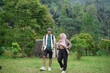 © Fajar - Young Indonesian female travelers wearing hijab and Indonesian male travelers enjoying a trip in nature, travel concept.