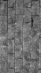 Poster - Wall of stones. Brick wall. Gray background with black geometric patterns, of rectangular stones, bricks. Part of a stone wall pattern for background, texture or text. rough grainy stone wall