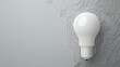© somchairakin - light bulb against gray background with circuit patterns, symbolizing innovation and technology