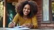 © Prostock-studio - A woman with curly hair enjoys a sunny day while writing notes in a cozy outdoor setting. She is brainstorming ideas related to real estate and AI, smiling as she engages with her work.