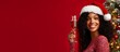 © tetxu - Smiling young woman in Santa Claus hat with glass of champagne near Christmas tree