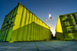 © VISTA by Westend61 - Man jumping over green containers