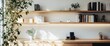 © milenialdesastudio - Sunlit minimalist workspace with wooden shelves, books, plants, and desk.
