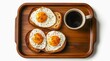 © Hanna - Cup of black coffee and toasts with fried eggs on a wooden tray, top view.