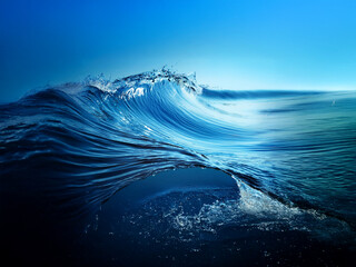 Poster - A majestic, translucent ocean wave curls, showcasing its powerful form against a deep blue sky.  The water's texture and movement are captivating.