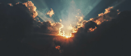 Poster - Radiant sunbeams breaking through dark clouds at dusk creating a serene atmosphere