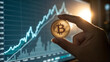 © stockpro - Hand holding shining bitcoin stock market background close-up view financial growth