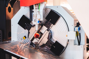 Fototapete - Machine cutting metal tube with laser. Industrial metalworking concept