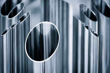 Poster - A row of metal pipes are lined up. The pipes are silver and have a circular cross section. Industrial metal background