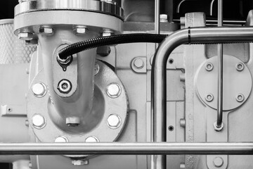Aufkleber - Close up of a metal pipe with a bolt on it. The bolt is in the middle of the pipe, and it is surrounded by several other bolts. The pipe is silver and he is part of a larger system