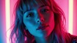 © yarku20 - Close-up portrait of a young woman with blonde hair, illuminated by vibrant pink and blue neon lights. Her expression is alluring and mysterious, creating a captivating image.