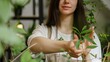 © ANC Media - A woman tends to lush green plants while promoting healthy eating habits during National Nutrition Month