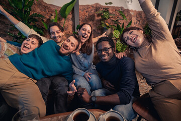 Wall Mural - Multiracial group laughing at cafe lounge