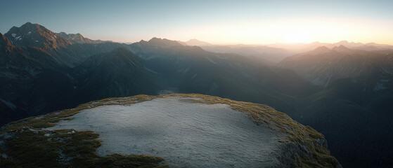 Wall Mural - A serene mountain landscape at sunset, highlighting rocky terrain and distant peaks under a soft, glowing sky.