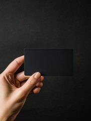 Poster - Hand holding a sleek black gift card with copy space for mock up design and personalization. Generative AI