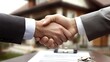 © luck - Businessmen shaking hands, contract and keys on table